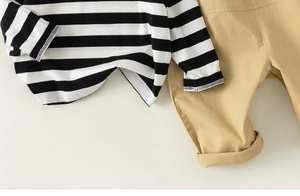 Detail of children striped long sleeve shirt and khaki twill fabric casual pants set