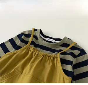 Detail of crew neck striped long sleeve shirt and mustard yellow overall for toddlers