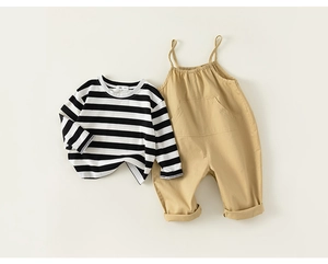 Flat lay of striped long sleeve shirt and khaki suspender pants for baby boy outfits