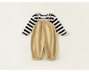 Flat lay of striped long sleeve shirt and khaki cotton overalls for baby boys
