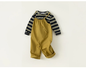 Flat lay of striped long sleeve tee and mustard yellow overalls for toddler boys
