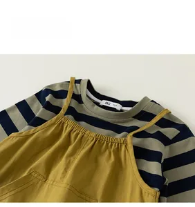 Detail view of striped cotton long sleeve shirt and mustard yellow suspender pants set