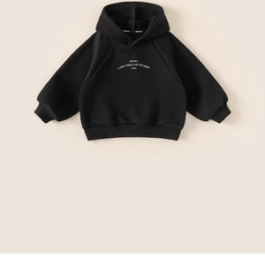 Detail of black hoodie showing ribbed cuffs and INSGOOD slogan print on thick fabric