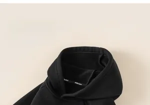 Detail of hooded neckline and thick fleece lining on black warm boys winter hoodie