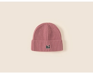 Detail of soft chunky knit beanie with 'hi' patch and warm ribbed texture finish