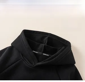 Detail showing the hood structure and fleece lining of the warm black boys' hoodie