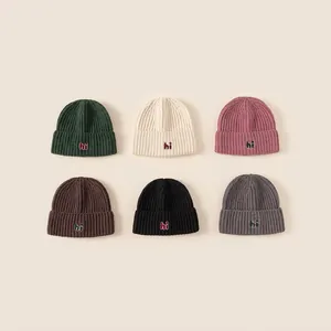 Set of six knitted winter beanies for kids with hi embroidery in assorted colors