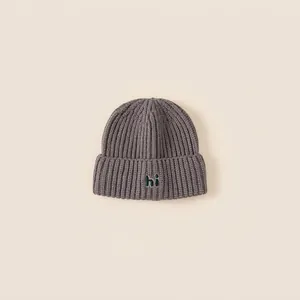 Cozy dark grey knit beanie for children featuring a green hi patch and ear protection