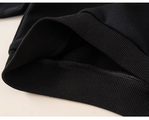 Detail of boys' winter hoodie showing black ribbed hem and soft warm fleece lining
