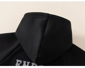 Detail view of boys fleece-lined black hoodie featuring high-quality stitching and hood structure