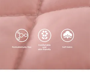 Detail of pink quilted fabric showing soft texture and high-quality diamond stitching