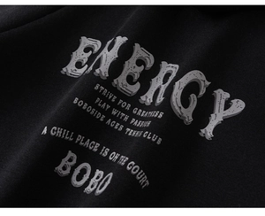 Detailed view of Energy slogan print on black cotton hoodie with premium fabric texture