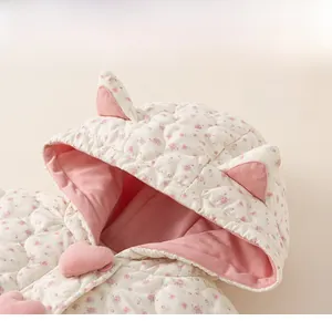 Detail of baby girl floral quilted coat hood with 3D cat ears and pink heart buttons