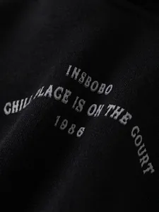 Boys black fleece hoodie with white lettering and 1986 sport graphic print
