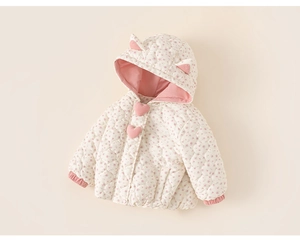 Detail of baby girl hooded quilted coat with pink floral patterns and cute heart accents