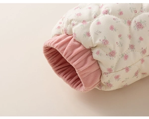 Detail of pink floral quilted fabric with cozy elastic ribbed cuffs for children jacket