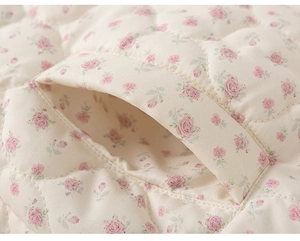 Detail of quilted floral toddler jacket showing premium stitching on pockets and fabric