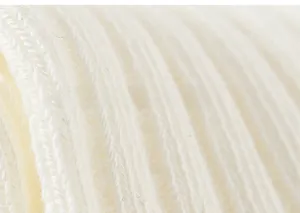 Macro shot of soft cream ribbed knit cotton fabric showing cozy texture and details