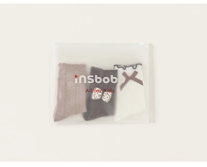 Three-pack of kids' socks in soft neutral tones displayed in a frosted zip-lock package