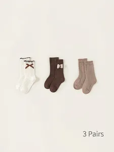 Three-pack of children's cotton socks in cream, coffee, and oatmeal with bows