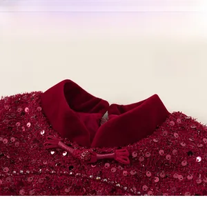 Close-up of wine red velvet collar with traditional knots and sparkling sequins