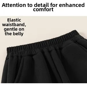 Close-up of high-elasticity waistband on black kids sweatpants with uniform pleats