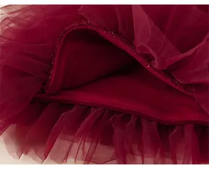 Detailed macro view of the loose wine red tulle hemline with soft velvet lining