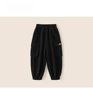 Detail of children's black jogger pants featuring elastic waist and cargo side pocket