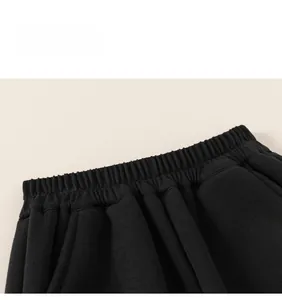 Close-up of black children sports pants featuring a high-elastic ribbed waistband and neat stitching