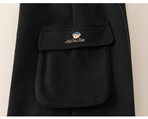 Detailed view of the thick fleece cargo pocket with bear embroidery on children's black pants