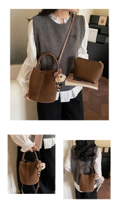 Close-up of deep brown matte leather bucket bag set with cute bear charm and strap detail