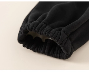 Close-up of elastic ribbed cuffs on children's black fleece-lined warm joggers