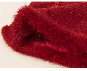Détail d'une robe d'hiver rouge avec tissu pailleté, bordure en fourrure et doublure