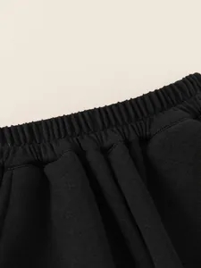 Kids black elastic waist sweatpants with fleece lining and thick knit cotton fabric