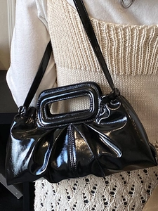 Chic black patent leather rectangular shoulder bag with unique hollow handle and pleated finish