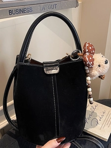 Retro black suede bucket bag with contrast stitching and cute plush bear charm