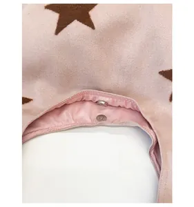 Detail view of the magnetic closure and smooth satin lining on this pink plush tote bag