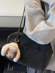Minimalist black tote bag for women featuring a plush rabbit pendant for daily commuting