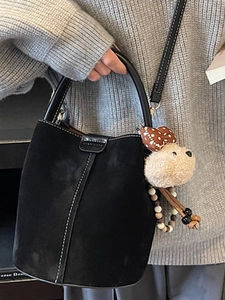 Retro black suede bucket bag with white stitching and plush bear charm for women