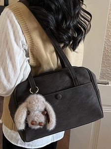 Vintage dark brown Boston bag with plush rabbit charm and magnetic front pocket