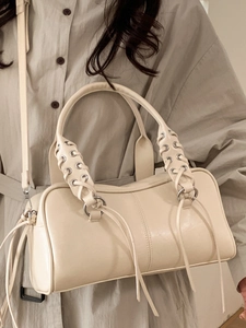 Minimalist beige bowling bag with woven handles and tassels for women's daily commute style