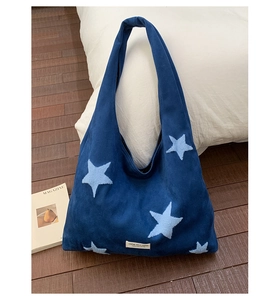 Detail of navy plush tote bag featuring soft star embroidery and high-quality fabric texture