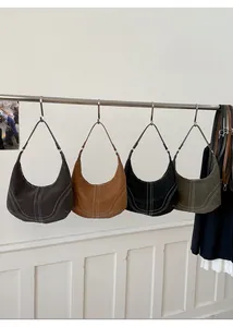 Detailed close-up showing four vintage hobo bags with unique vertical stitching details