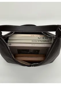 Top macro view showing large capacity interior of dark brown leather shoulder bag