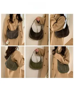 Detail view of large leather hobo bag with contrast stitching in black and green