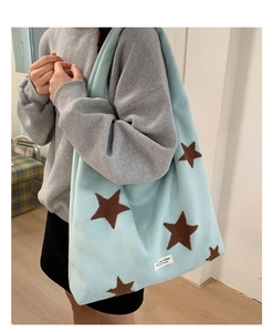 Detail of light blue fuzzy star tote bag showing large capacity and soft plush texture