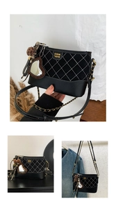 Detail of black quilted crossbody bag with heart mirror charm and leopard fur ball