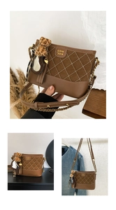 Close-up of brown quilted shoulder bag with gold chain strap and leopard print charm