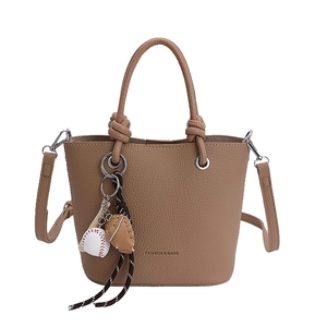 Brown lychee leather bucket bag with top handle, fashion bags logo and baseball charm