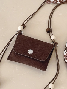 Mini dark brown suede crossbody bag with decorative wooden beads and metallic button